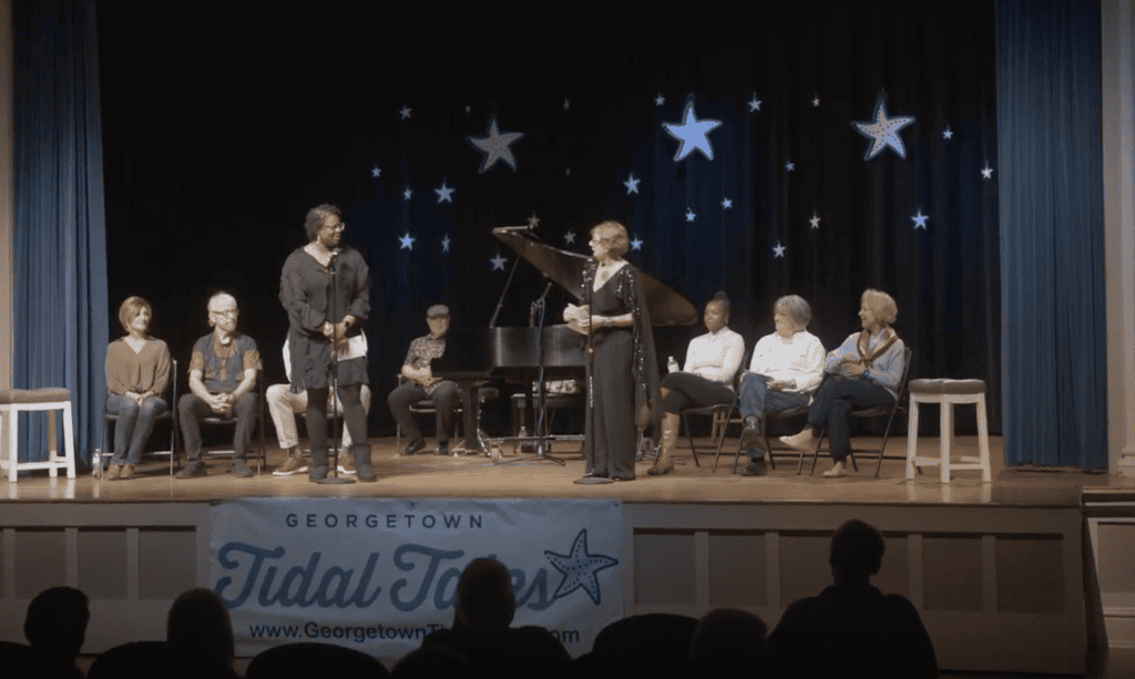 Live storytelling performance at a Georgetown Tidal Tales community event powered by a Bluehost website.